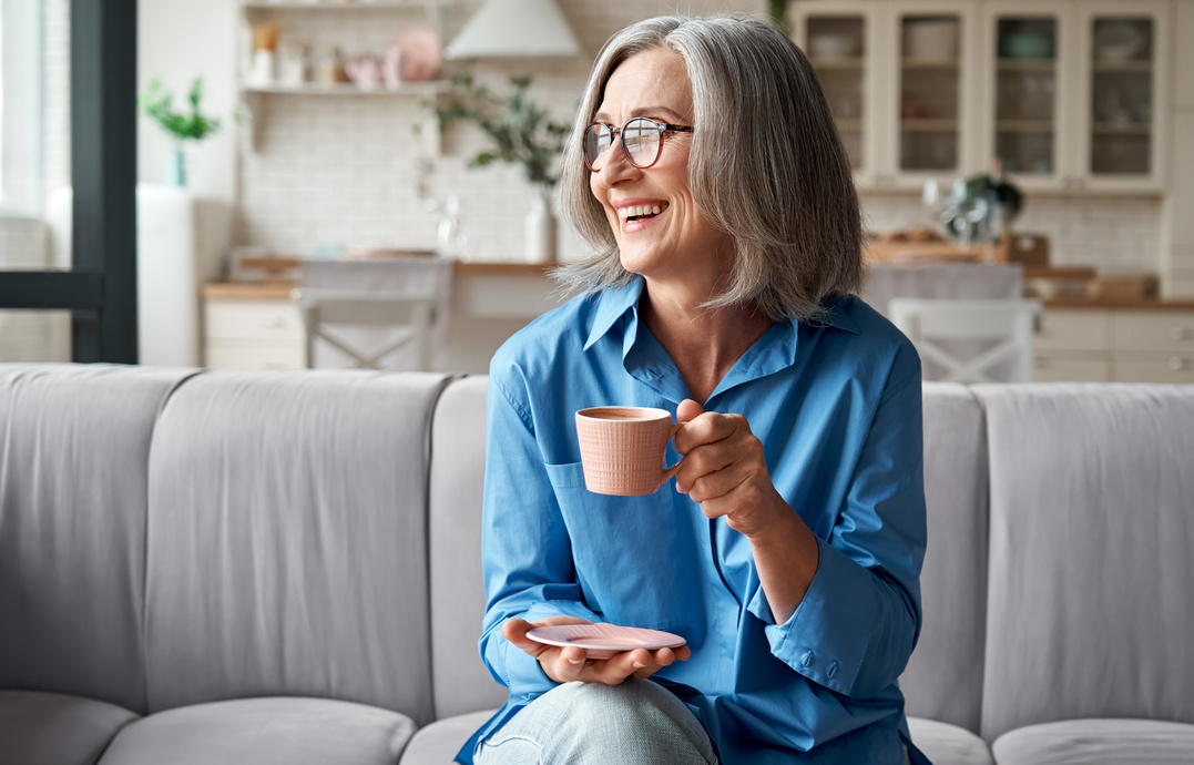 Happy Mature Older Woman Drinking Coffee at Home
